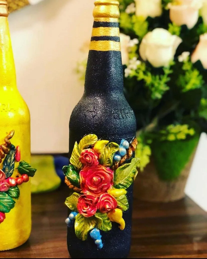 Hand-painted glass bottle with clay flowers